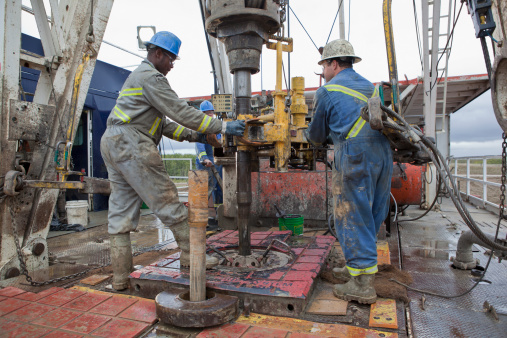 Oil workers drilling for oil on rig